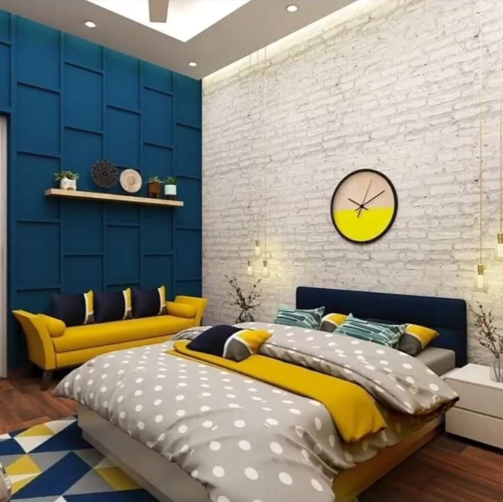 Modern bedroom interior design with exposed white brick wall, deep blue grid accent paneling, yellow sofa, and cove ceiling lighting