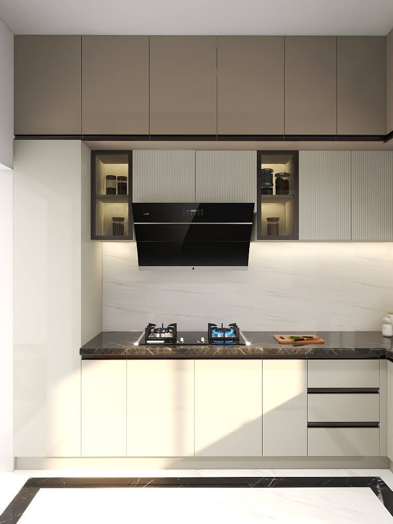 Modern modular kitchen design with dual-tone beige and taupe cabinets, built-in cooktop, slanted black chimney, under-cabinet profile lighting, and fluted glass display shutters